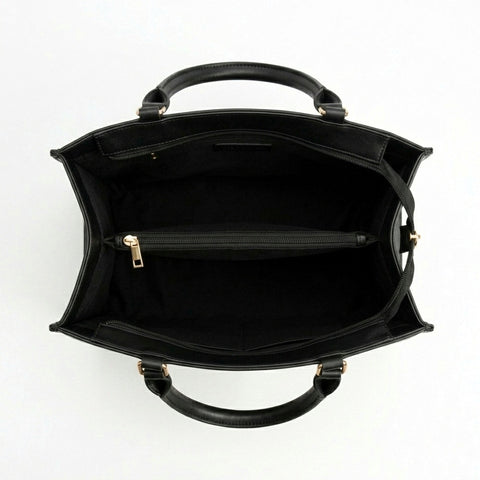 Black bag with gold hardware on a white backgrountote 